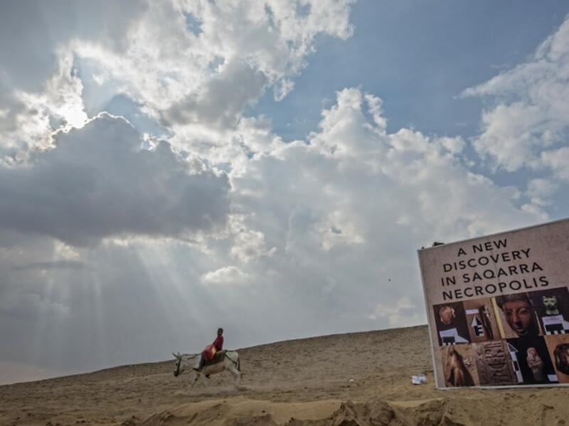 A boy rides a donkey near a new discovery made by an Egyptian archaeological mission. (KHALED DESOUKI / AFP)
