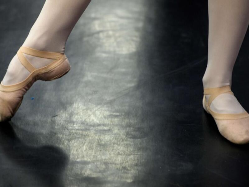 A girl attends a class at a ballet studio in Moscow on November 22, 2018. In a small studio in northern Moscow, parents and grandparents sit in a corridor waiting for children as young as three to finish their ballet class. 
Mladen ANTONOV / AFP