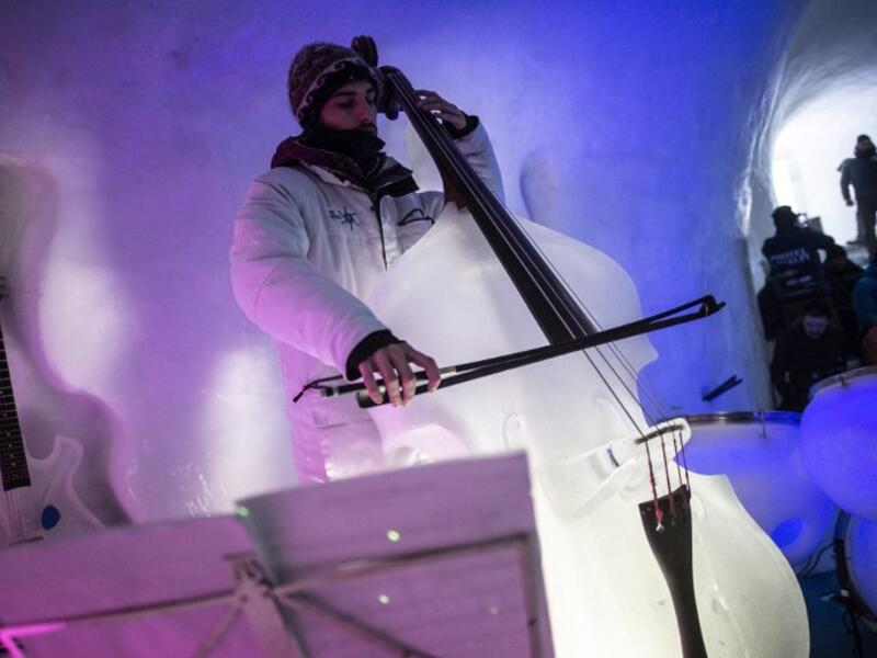 A musician performs with an ice violin during a concert in the "Ice Dome" on Presena Galcier, Tonale Pass, near Trento in northern Italy on January 17, 2018. 
Marco BERTORELLO / AFP