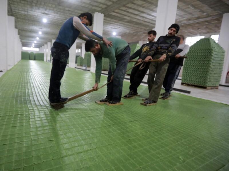 Syrian workers cut olive soap bars in a factory on the outskirts of Aleppo 
LOUAI BESHARA / AFP