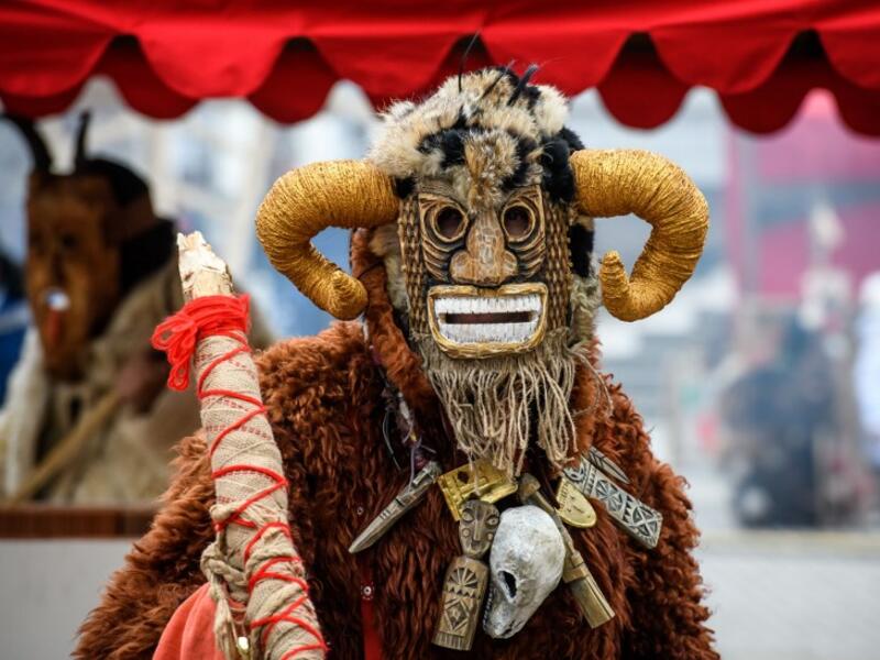 A performer in a scary mask entertains the public during the Shrovetide spring festival outside the Kremlin in Moscow on March 01, 2019. Mladen ANTONOV / AFP