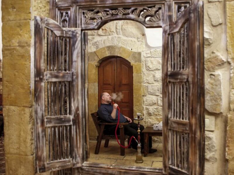 A man smokes a waterpipe (shisha or hookah) at the premises of the first traditional Turkish bath (Hammam) opening in the occupied Palestinian West Bank city of Hebron on March 11, 2019.
HAZEM BADER / AFP