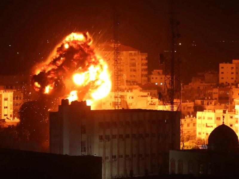 A ball of fire billows above buildings in Gaza City during reported Israeli strikes on March 25, 2019. Israel's military launched strikes on Hamas targets in the Gaza Strip today, the army and witnesses said, hours after a rocket from the Palestinian enclave hit a house and wounded seven Israelis.
Majdi Fathi / AFP