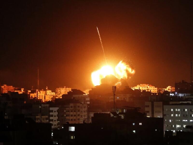 A ball of fire lights the sky above a building believed to house the offices of Hamas chief in Gaza, Ismail Haniyeh, during Israeli strikes on the Gaza City, on March 25, 2019.
Mahmud Hams / AFP