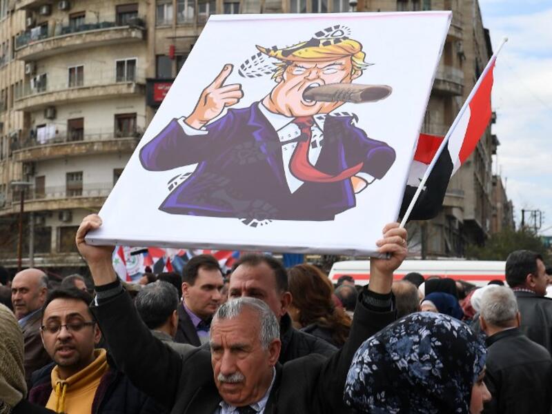 Syrians protest in the northern city of Aleppo against the US decision to recognise Israel's sovereignty over the Golan Heights on March 26, 2019. 
GEORGE OURFALIAN / AFP