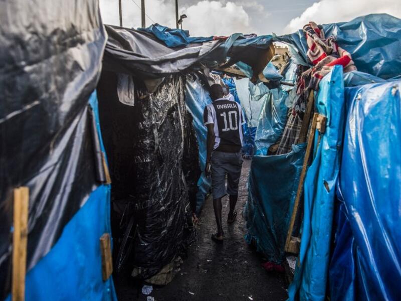 A sub-Saharan migrant walks between make-shift tents in the Oulad Ziane migrant camp in Casablanca on March 27, 2019. 
FADEL SENNA / AFP