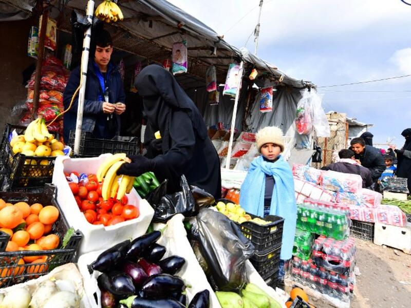 Displaced women buy vegetables and fruits in the souk or market of Al-Hol camp for displaced people in northeastern Syria
GIUSEPPE CACACE / AFP
