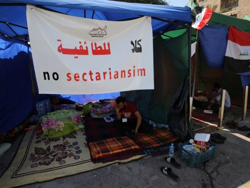 A supporter of Iraqi Shia cleric Moqtada al-Sadr sits inside a tent on the fourth day of a sit-in calling for governmental reform and elimination of corruption on March 22, 2016, outside the main gates of Baghdad's Green Zone. (AFP/Ahmad al-Rubaye)