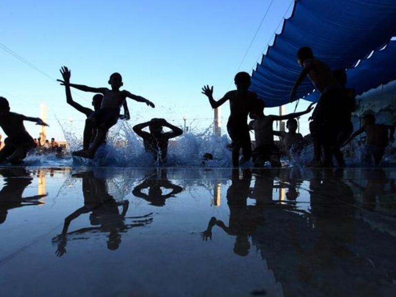 Palestinian children jump into a swimming pool in the village of Hawara, near the West Bank city of Nablus, on August 9, 2013, a day after Eid al-Fitr celebrations following the Islamic holy month of Ramadan. (AFP)