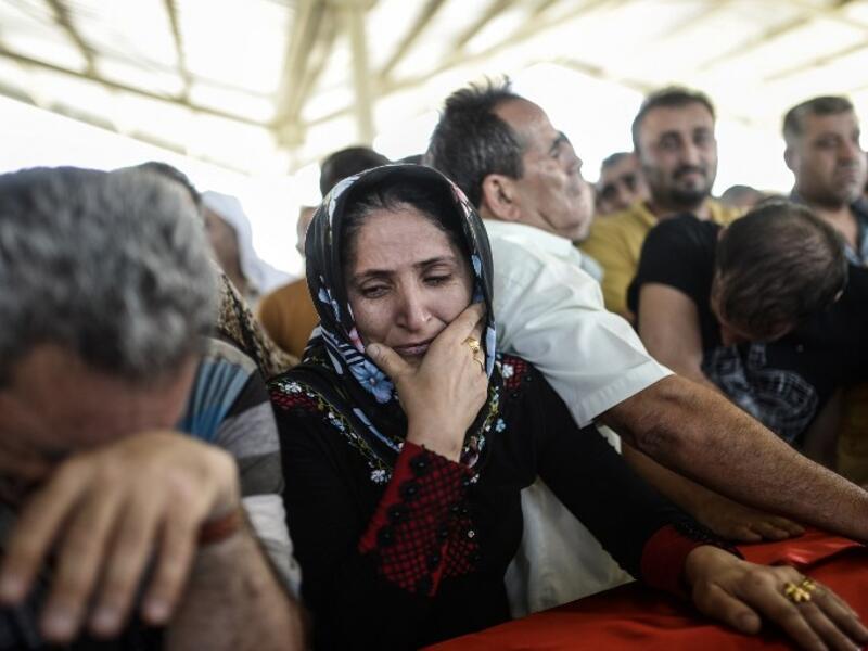 Family members of the victims of the suicide bombing attack in the Turkish city of Suruc gathered for a funeral service on Tuesday, July 21, 2015. (AFP/Bulent Kilic)

