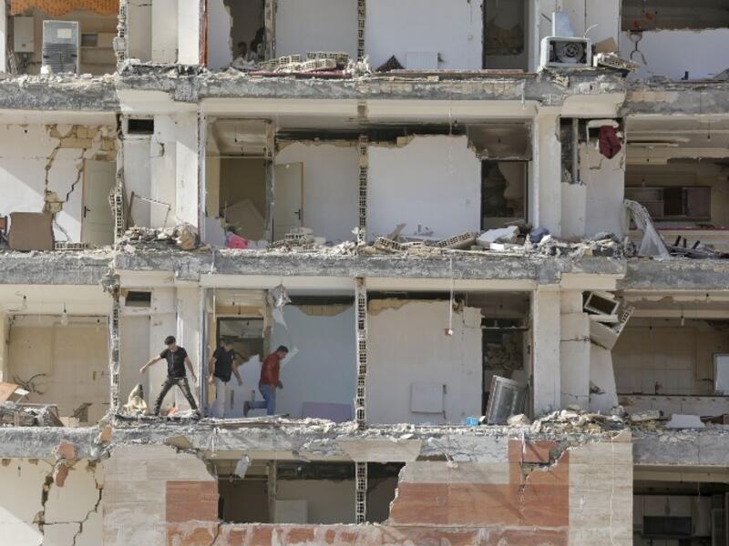 This picture shows a view through the buildings left damaged by the 7.3-magnitude earthquake that struck days before in the town of Sarpol-e Zahab in Iran's western Kermanshah province near the border with Iraq, leaving hundreds killed and thousands homeless. 

(ATTA KENARE / AFP)