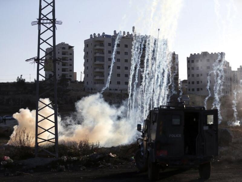 Israeli forces fire teargas at Palestinian demonstrators during clashes near an Israeli checkpoint in the West Bank city of Ramallah.
(ABBAS MOMANI / AFP)