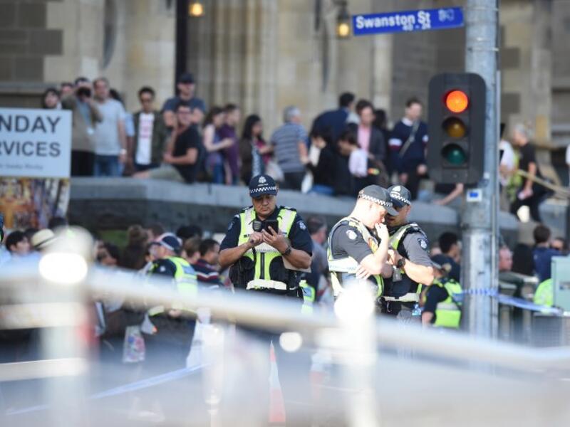 Police and emergency personnel work at the scene of where a car ran over pedestrians in Flinders Street in Melbourne on Dec. 21, 2017 (Mal Fairclough / AFP)