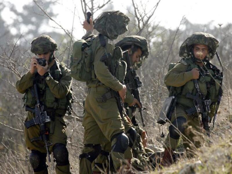  Israeli soldiers patrolling along the Israeli border (AFP/File Photo)