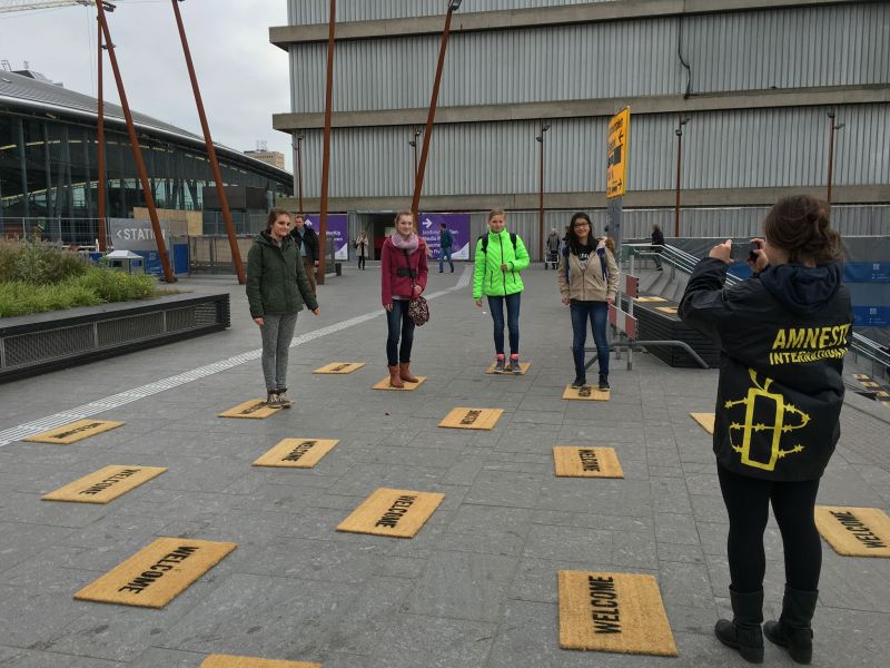 Students lay down "welcome" door mats for Syrian refugees in Netherlands as part of the Utrecht Welcomes Refugees project for Amnesty International. 
