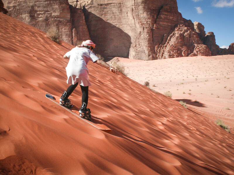 Girl sand boarding on dunes in Wadi Rum, Jordan (Shutterstock/File Photo)