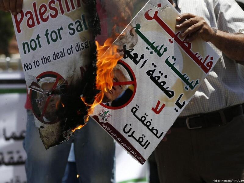Palestinians protest against Trump's deal of the century in the West Bank city of Ramallah on 2 July 2018 [Abbas Momani/AFP/Getty Images]