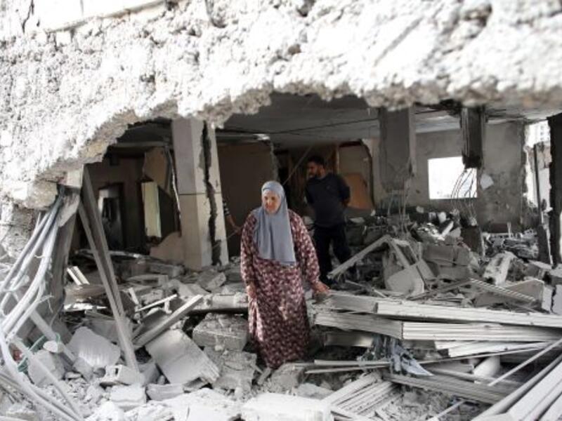 A Palestinian woman walks amid the rubble of a house after Israeli security forces demolished the homes of two convicted Palestinian terrorists in Jabal Mukkaber in East Jerusalem, October 6, 2015. (AFP/File)