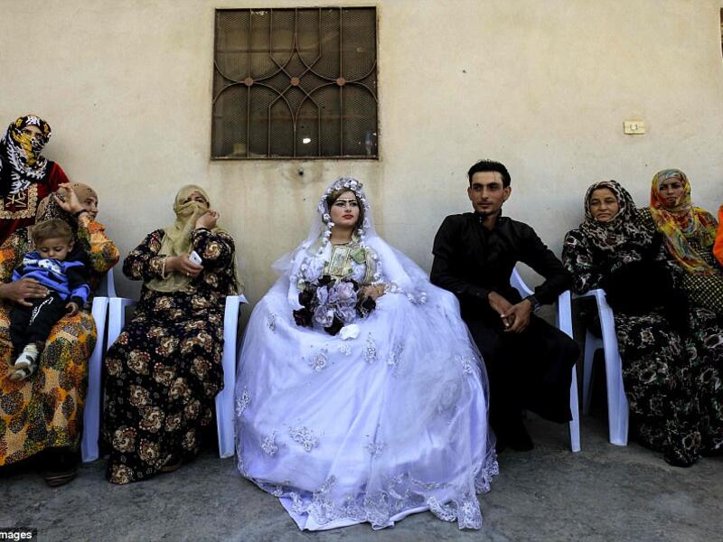 Around the couple, guests took photos with mobile phones while little girls also made-up with darkened eyebrows and colored lips danced to the beat of the music (AFP)