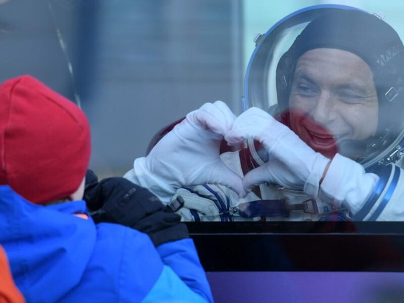 David Saint-Jacques of the Canadian Space Agency, a member of the International Space Station (ISS) expedition 58/59, gestures from inside a bus as he leaves to board the Soyuz MS-11 spacecraft shortly before the launch at the Russian-leased Baikonur cosmodrome in Kazakhstan on December 3, 2018. 
Kirill KUDRYAVTSEV / AFP