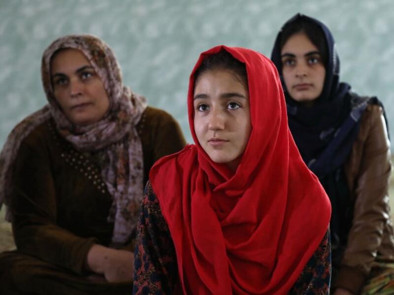Women and young girls listen to Rasul, an Iraqi Kurdish activist with the non-profit organisation WADI, as she peaks about the harms of genital mutilation in Sharboty Saghira, a small village east of regional capital Arbil.
SAFIN HAMED / AFP