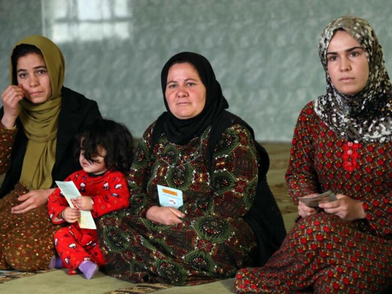 Women and young girls listen to Rasul (not pictured), an Iraqi Kurdish activist with the non-profit organisation WADI, as she peaks about the harms of genital mutilation in Sharboty Saghira.
SAFIN HAMED / AFP