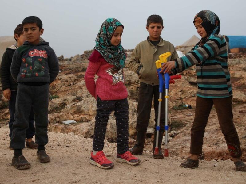 Maya Merhi (C) stands among her friends in the Internally Displaced Persons (IDP) camp of Serjilla in northwestern Syria, next to Bab al-Hawa border crossing with Turkey.
Aaref WATAD / AFP