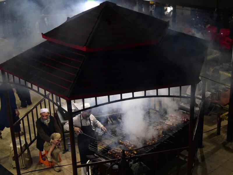 Pakistani man cooks grilled meat on a barbeque at the Charsi (Hashish) Tikka restaurant in Namak Mandi in Peshawar.
ABDUL MAJEED / AFP