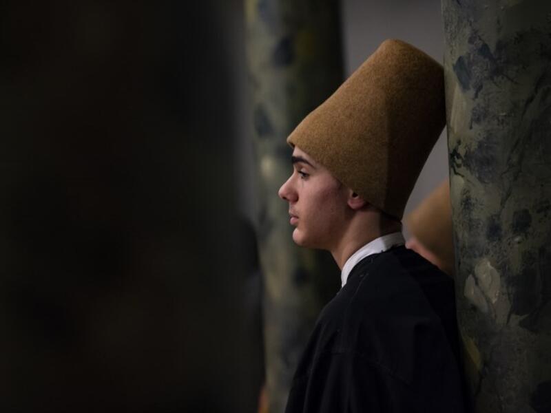 A dervish looks on during a ceremony marking the anniversary of the death of Jelaleddin Mevlana Rumi, Sufi mystic, poet and founder of the sufism on December 16, 2018 at Galata Mevlihanesi in Istanbul. Yasin AKGUL / AFP