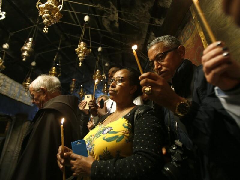 Christian worshippers pray inside the Grotto on December 22, 2018, three days ahead of the Christmas celebration. Musa Al Shaer/AFP 
