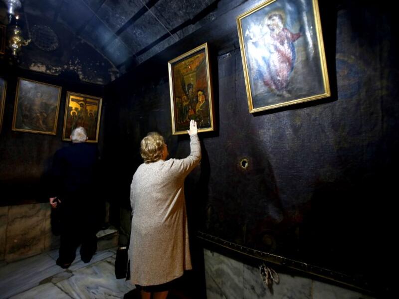 Christian worshippers pray inside the Grotto, believed to be the exact spot where Jesus Christ was born, at the Church of the Nativity in the biblical West Bank city of Bethlehem, on December 22, 2018, three days ahead of the Christmas celebration. Musa Al Shaer/AFP
