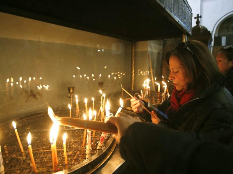 Christian worshipers light candles at the Church of the Nativity in the biblical West Bank city of Bethlehem, on December 22, 2018, three days ahead of the Christmas celebration. Musa Al Shaer/AFP 