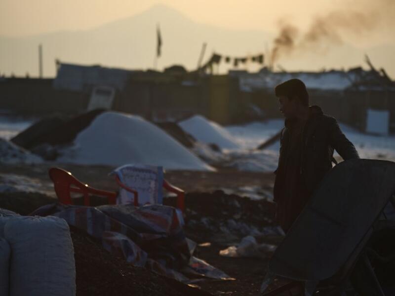 In this picture, an Afghan day labourer stands next to a wheelbarrow at a coal yard amid heavy smog conditions in the outskirts of Kabul. 
WAKIL KOHSAR / AFP