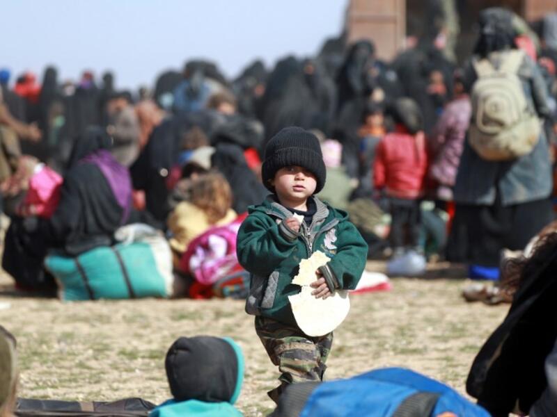 People who fled battles between Syrian Democratic Forces (SDF) and ISIS fighters in the Syrian village of Baghouz, arrive after crossing a desert in the back of a truck to a region controlled by the SFD in the countryside of the Deir Ezzor province. Delil SOULEIMAN / AFP