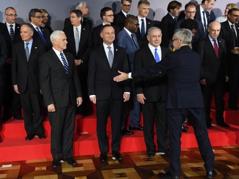 US Vice President Mike Pence, Poland's President Andrzej Duda and Prime minister of Israel Benjamin Netanyahu are seen during preparations for a family photo at the conference on Peace and Security in the Middle east in Warsaw, on February 13, 2019 
Janek SKARZYNSKI / AFP