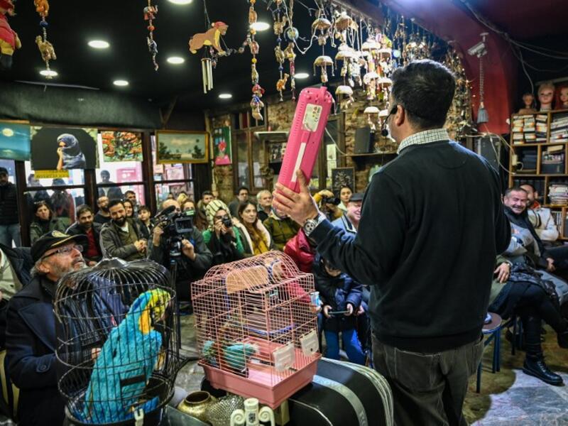 An auctioneer shows items to the audience at an auction house in Istanbul's Balat district.
OZAN KOSE / AFP