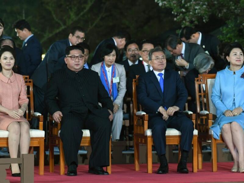 North Korea's leader Kim Jong Un (2L) and his wife Ri Sol Ju (L) sit with South Korea's President Moon Jae-in (2R) and his wife Kim Jung-sook (R) during a farewell ceremony  at the end of a  "threshold of a new history" summit. Korea Summit Press Pool / AFP