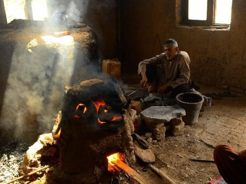 An Afghan man works at a factory which produces traditional glassware handicrafts in Herat (AFP)