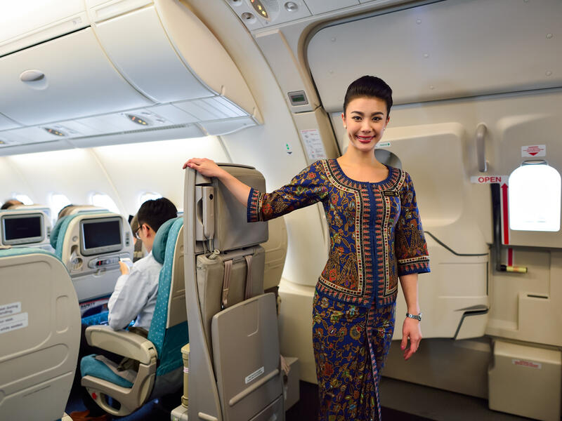 Singapore Airlines crew member on board (Shutterstock)