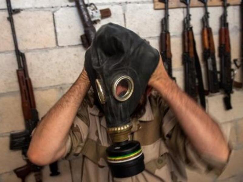 A Syrian rebel tries on a gas mask in the northwestern province of Idlib, on July 18, 2013. (AFP/File)