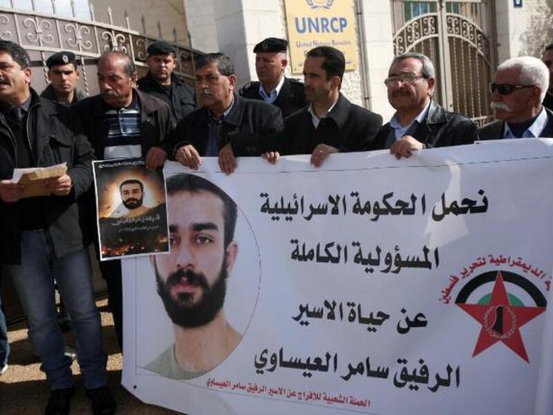 Palestinian protesters hold placards during a demonstration in Ramallah in support with Palestinian prisoners held in Israeli jails, some of whom are observing a hunger strike. (AFP PHOTO/ABBAS MOMANI)