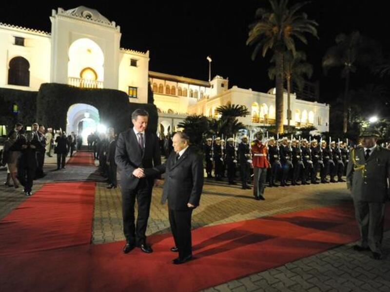 Algeria's President Abdelaziz Bouteflika (R) greets British Prime Minister David Cameron upon his arival at the People's Palace in the capital Algiers on Thursday. (AFP PHOTO/ FAROUK BATICHE)