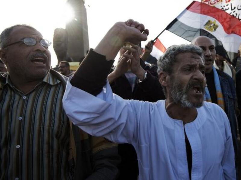 Egyptian anti-government protestors shout political slogans as they wave their national flag and banners during a march towards Cairo's landmark Tahrir. (AFP PHOTO/GIANLUIGI GUERCIA)