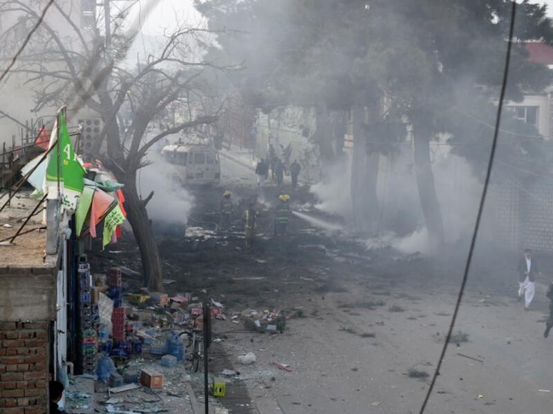 Afghan firefighters work to extinguish fire at the site of an explosion in Kabul on March 13, 2017. (AFP/Wakil Kohsar)