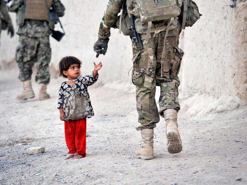 An Afghan girl greets a joint patrol of US troops from the Charlie Company. (AFP/ File)