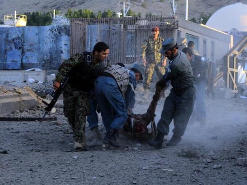 Security forces lift dead body of colleague after Taliban attack on US consulate. [AFP]