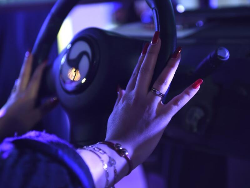 A Saudi woman uses a driving simulator during a driving workshop for women in the Saudi capital Riyadh on June 21, 2018. 
FAYEZ NURELDINE / AFP