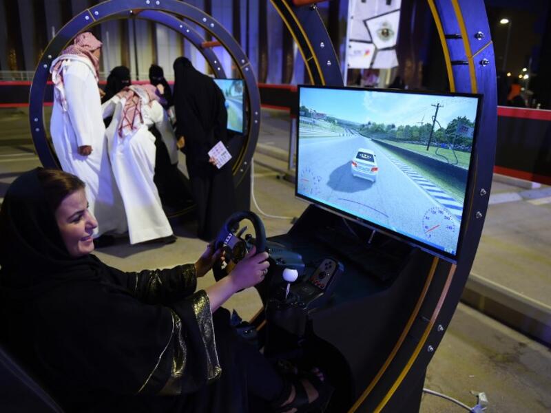 A Palestinian woman residing in Saudi Arabia uses an electronic driving simulator during a go-cart driving workshop for women in the Saudi capital Riyadh on June 21, 2018. 
FAYEZ NURELDINE / AFP