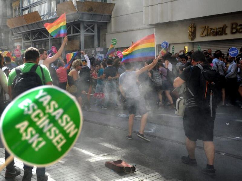 People run as Turkish riot police uses rubber bullets and tear gas to a Gay Pride (AFP/Ozan Kose)