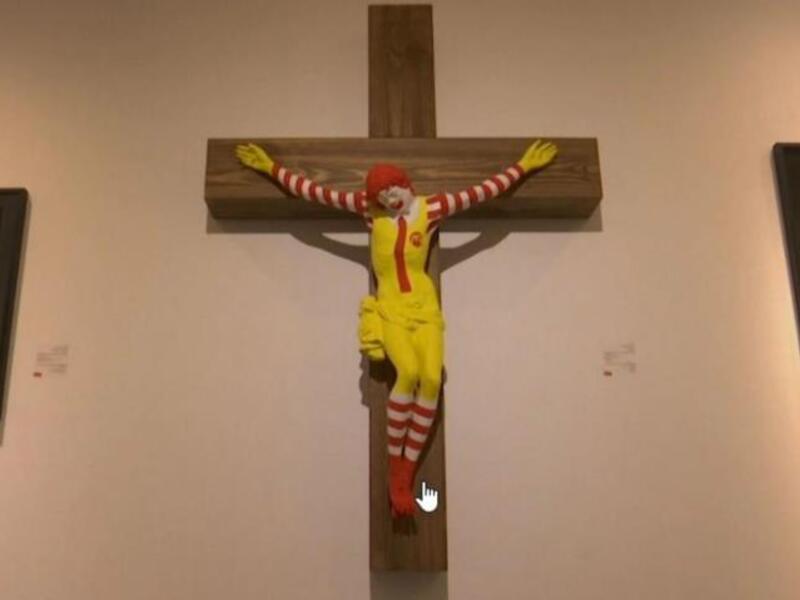 An art exhibit depicting a fast-food clown nailed to a cross is to be taken off. (Twitter)